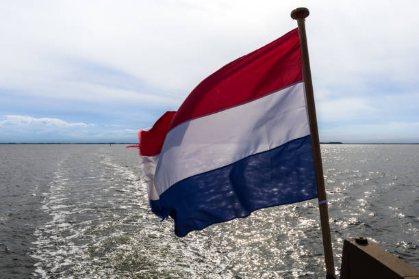 Dutch flag on a historic sailing vessel, in background baltic sea