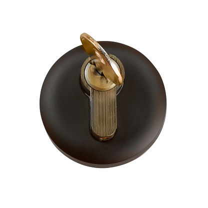Golden key inserted into the keyhole close up. Isolated on white, clipping path included