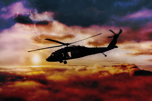 Black Hawk helicopter flying through a stormy sky can transport a group of soldiers into battle.