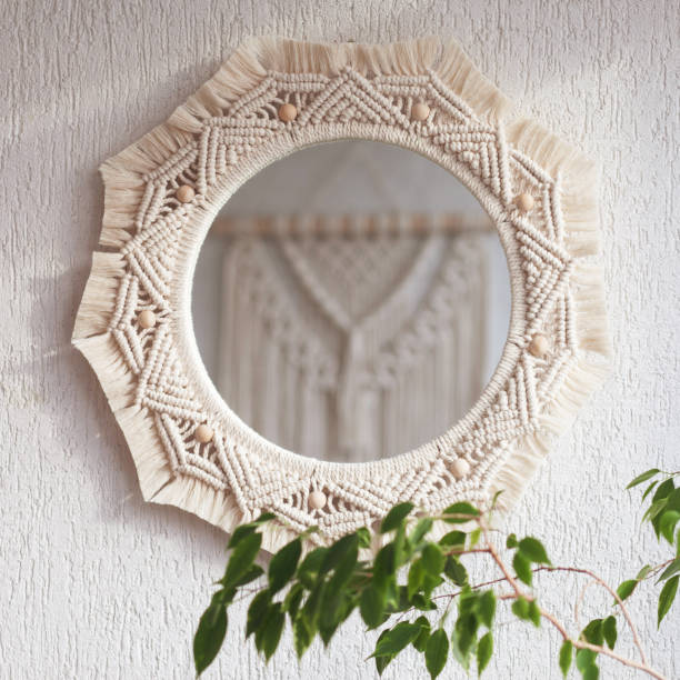 istock Macrame mirror on a white wall.  The mirror reflects macrame wallhanging. Eco-style. Natural materials. Soft fokus 1430447821