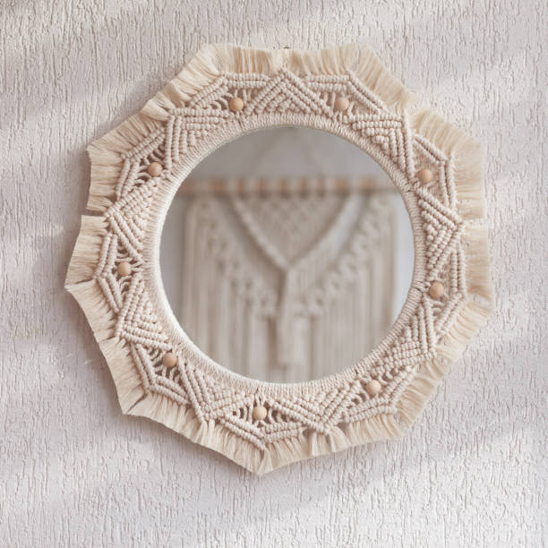 istock Macrame mirror on a white wall.  The mirror reflects macrame wallhanging. Eco-style. Natural materials. Soft fokus 1430447834