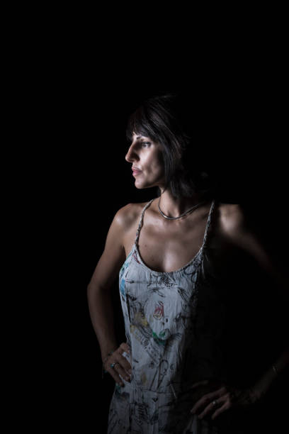 istock young woman with black hair on black background 1430450138