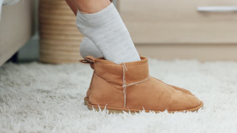 Shoes, bedroom and woman feet wake up from bed rest, sleeping and start good morning after relaxing at home. Closeup female foot dressing in comfortable lounge slippers on carpet floor for walking