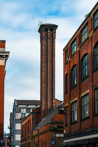 Brick chimney of the factory on the background of the blue sky