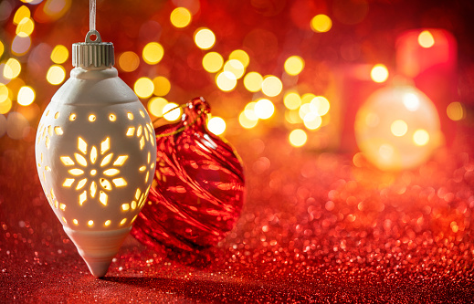 Christmas Baubles with snowflake glowing in red glowing sparkling background blurred