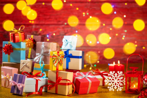 istock Many gift box stacked as a Christmas gift boxes arrangement on red glitter background 1430461581