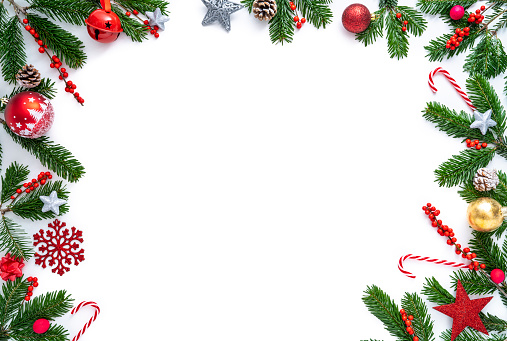 Christmas border frame with fir tree and holly berries , baubles, snowflake, candy cane isolated on white background