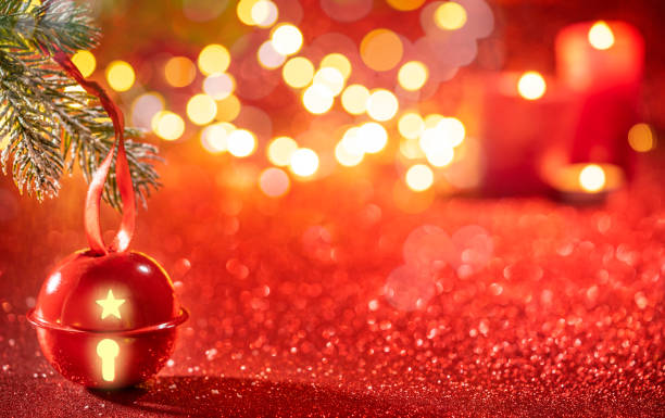 istock Red Jingle bell glowing with Christmas lights on sparkling red b 1430462760