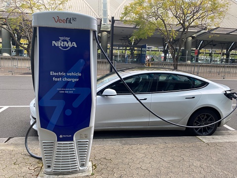 Sydney, Australia - 28 September 2022: An electric vehicle charging on an NRMA charging unit. Sydney Olympic Park, Sydney, Australia.