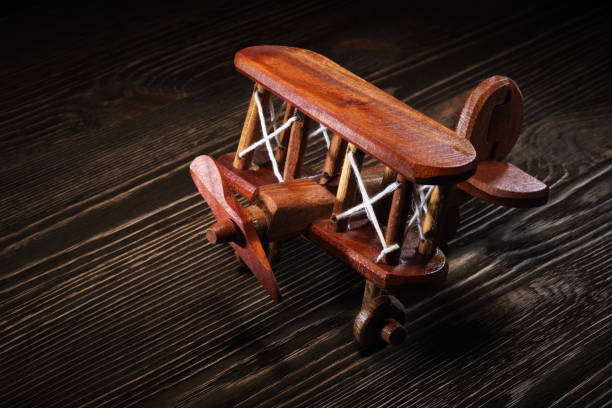 Wood toy plane hand made model on rustic wooden table.