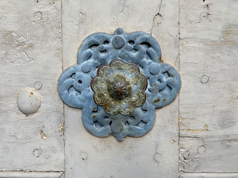 Decorative design of the keyhole. The face of the castle in the old style against the background of a tree.