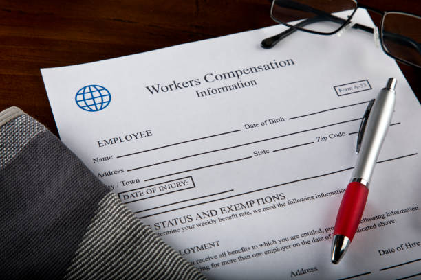 istock Worker Compensation Form with knee brace, glasses and pen 1430478245