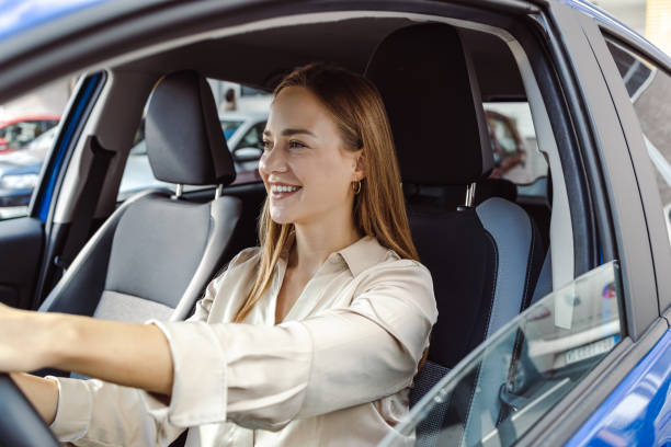 istock Young woman driving car and enjoying 1430486546