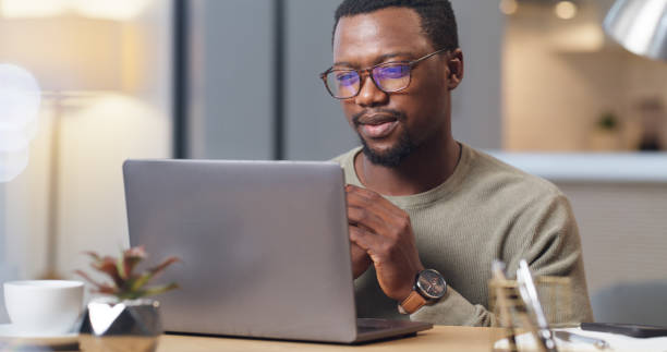 istock Thinking, business man and reading laptop email pitch for project proposal logistics in office. African entrepreneur with glasses contemplating decision on professional idea response online. 1430486608