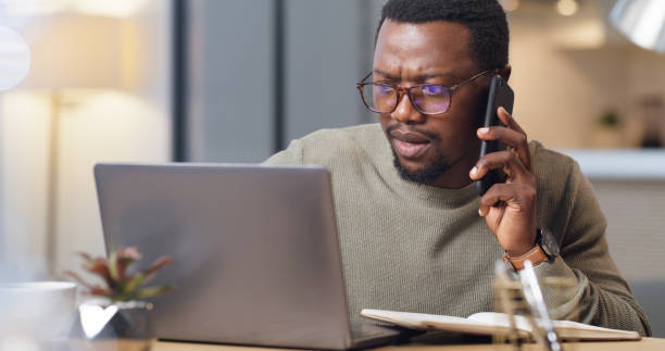 istock Laptop, black man and phone call shocked in office, talking or conversation after reading online fake news. Glitch, error and businessman on mobile smartphone with financial loss business deal email. 1430486617