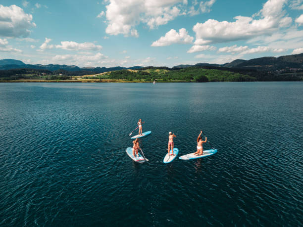 istock Instruction teaching women how to paddle board 1430490473