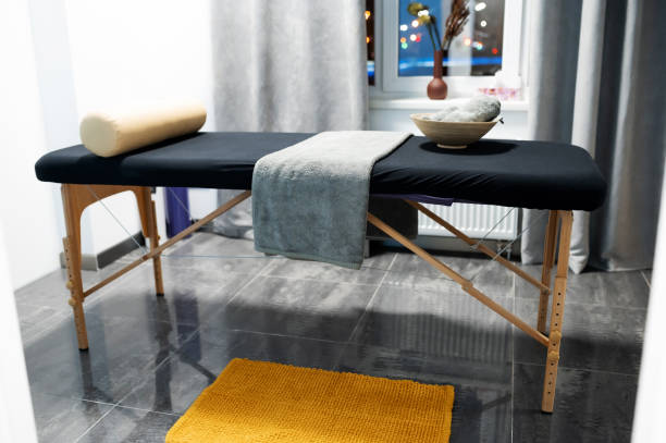 istock massage table with towels, head pillow in the massage room 1430496012