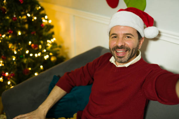 istock Happy man posting a selfie on social media during christmas 1430507084