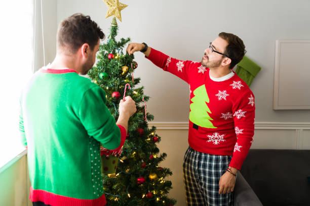 istock Happy gay couple decorating their christmas tree 1430507476