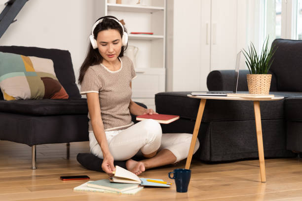 istock Woman studying online from her living room 1430507720