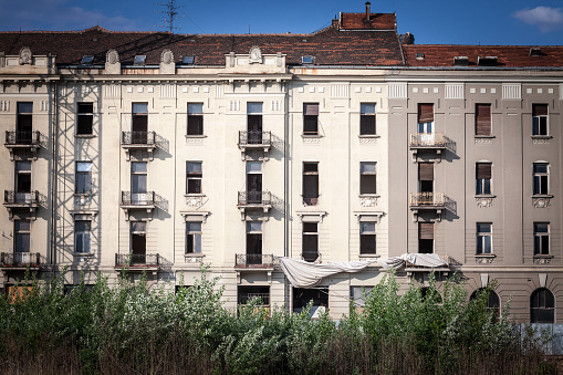 Facade of a abandoned hotel, in derelict, in Europe, seen from the outside, ready for renovation and urban renewal.