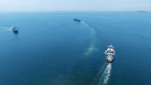 Stern of large cargo ship import export container box on the ocean sea on blue sky back ground concept transportation logistic and service to customer and supply change