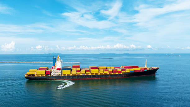istock Side of cargo ship carrying container and running 1430508755
