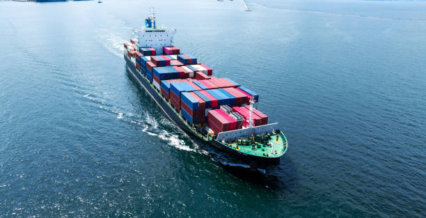 istock Aerial front of cargo ship carrying container and running 1430508967