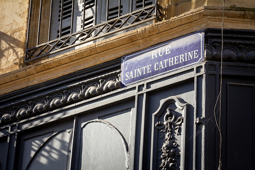 Picture of a street sign of Rue Sainte Catherine in Bordeaux, France. The rue Sainte-Catherine, a 1.2 km long pedestrian street, is the main shopping street in Bordeaux, France. Located on the former Roman cardo, this street is one of two main lines running through the historic part of the city.