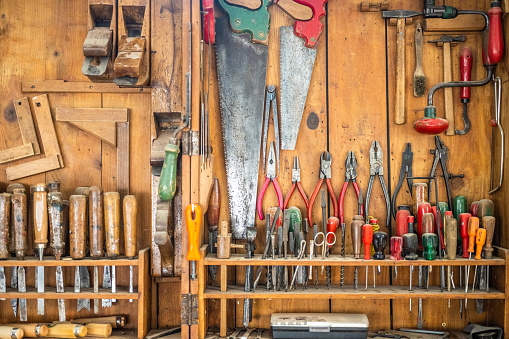 Nice shot of tool storage in workshop, various hand tools for wood processing. Wood material processing in carpentry, handmade craftwork products.