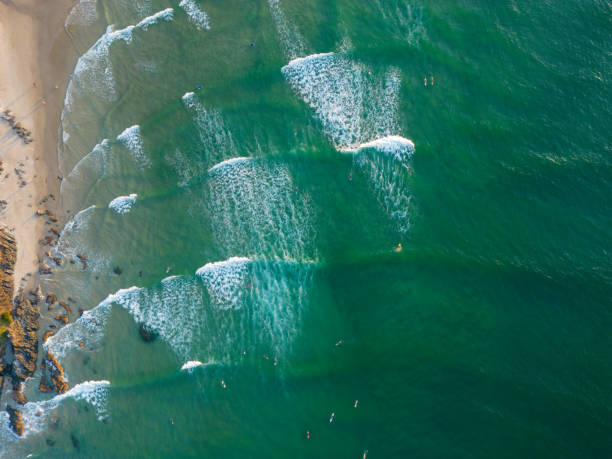 Late afternoon surfers in the line-up at Byron Bay, Australia