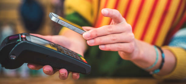 istock Hand of customer paying with contactless by mobile device. Payment with mobile. 1430520984