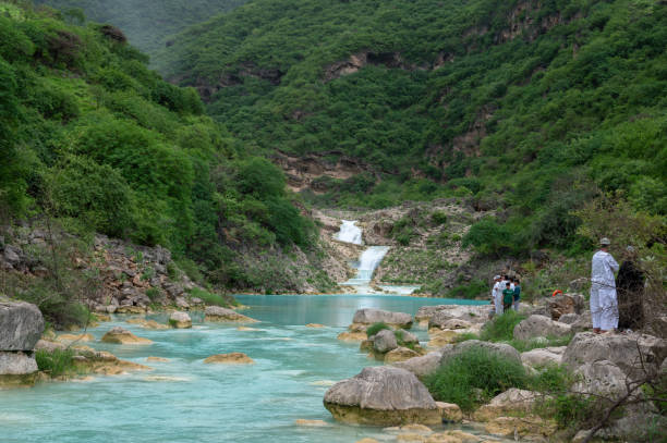 Small waterfalls in Wadi Darbat, Salalah, Oman, which becomes inundated during the rainy Khareef (autumn) season in this otherwise arid country.People visible.
