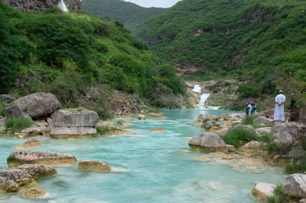 Small waterfalls in Wadi Darbat, Salalah, Oman, which becomes inundated during the rainy Khareef (autumn) season in this otherwise arid country.People visible.
