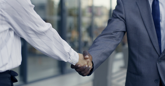 Management shaking hands, business meeting and consulting, hiring and agreement for deal, partnership and onboarding in office. Executive welcome handshake, promotion opportunity and thank you trust