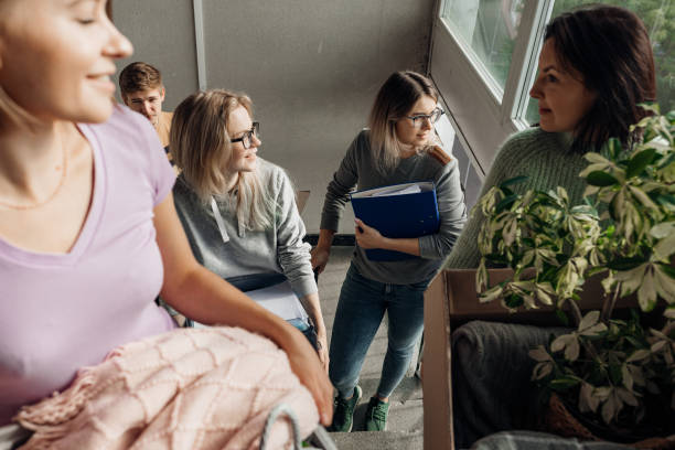 istock Smiling, foretaste, anticipating students carrying luggage on the stairs, talking while relocation. First year education 1430535349