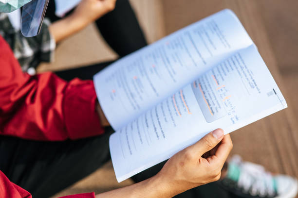 istock A male student wearing a mask and sitting reading. 1430539822