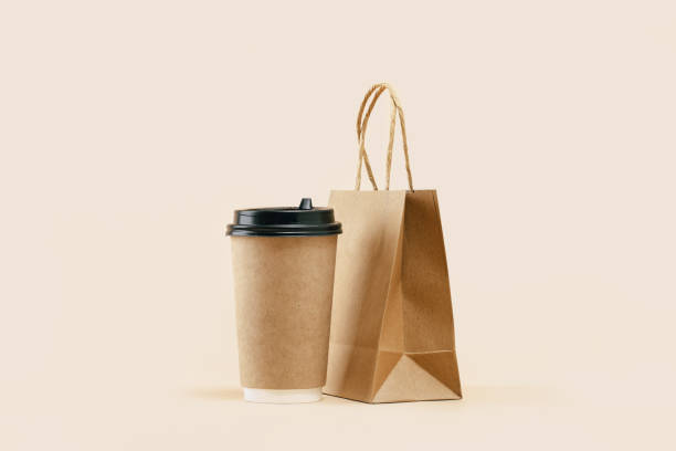 istock Takeaway paper coffee cup with lunch bag on beige 1430541239