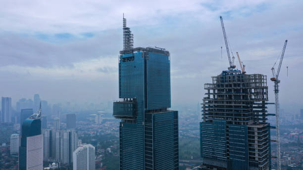 Skyscraper under construction, with crane on top, for urban and industrial themes