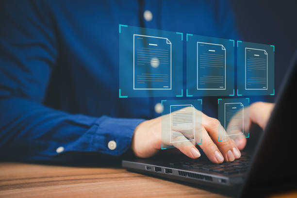 istock Businessmen use laptop computer with virtual screens and documents to approve paperless quality assurance concepts online. 1430544527