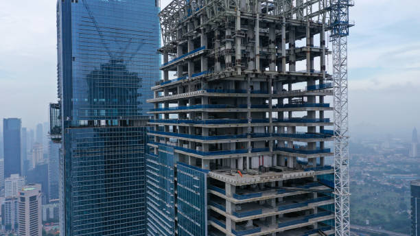 istock Skyscraper under construction, with crane on top, for urban and industrial themes 1430544627