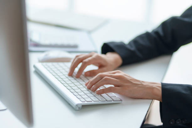 Close-up of business woman  typing on his laptop computer in the office. stock photo