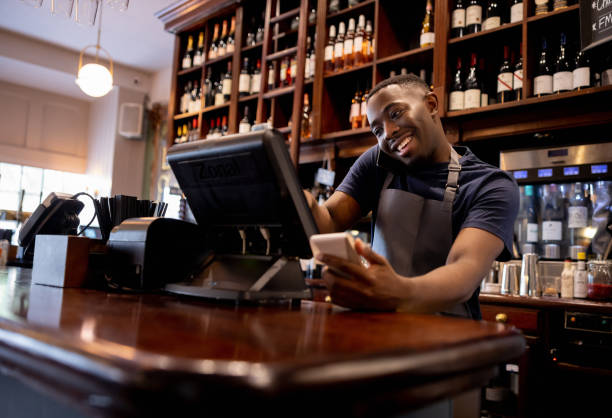 istock Waiter working at a pub and talking on the phone 1430548724