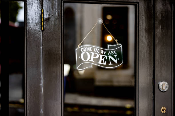 Open sign hanging on the door of a restaurant Close-up on a open sign hanging on the door of a restaurant - food and drink establishment concepts night club door stock pictures, royalty-free photos & images