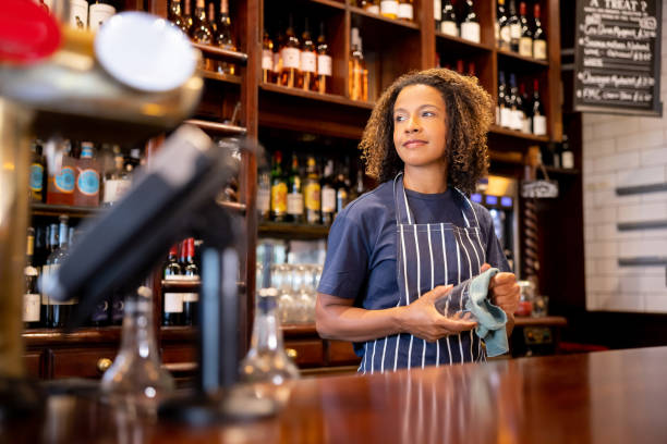 istock Waitress working at a pub and drying some glasses 1430548768