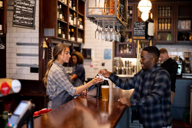 istock Man making a contactless payment at the pub 1430548791