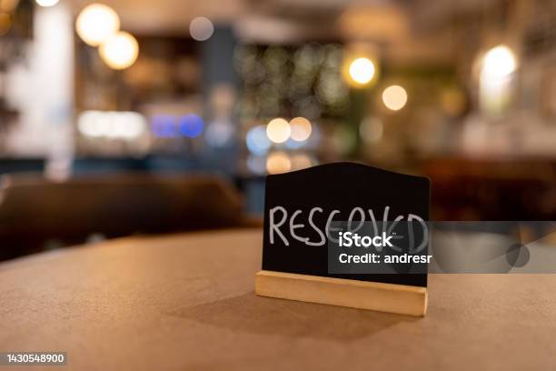 Closeup On A Reserved Sign On A Table At A Restaurant Stock Photo - Download Image Now