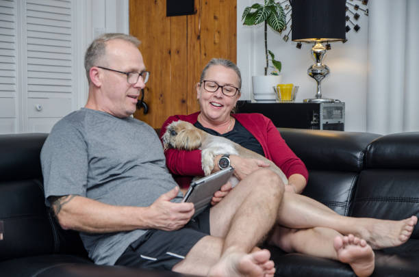 istock Mature couple looking at tablet on sofa 1430549730