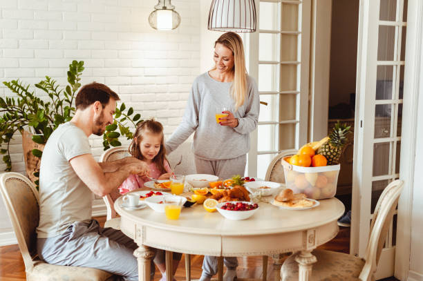 istock Happy young family having breakfast at home 1430554001