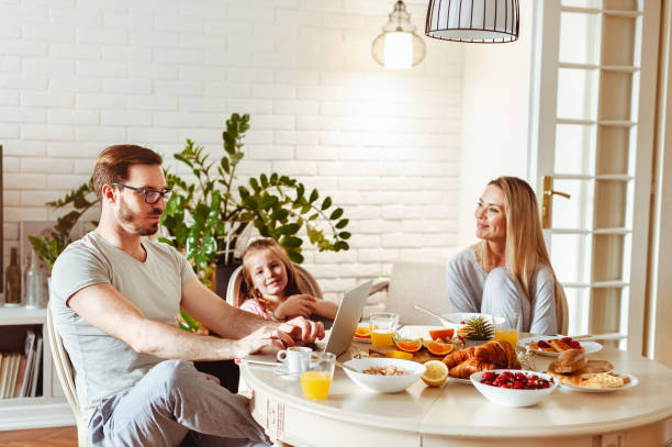 istock Happy young family having breakfast at home 1430554069